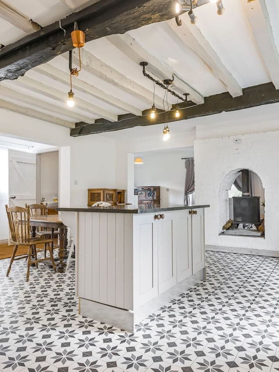 Equipped open plan kitchen with dining table opening up to the garden