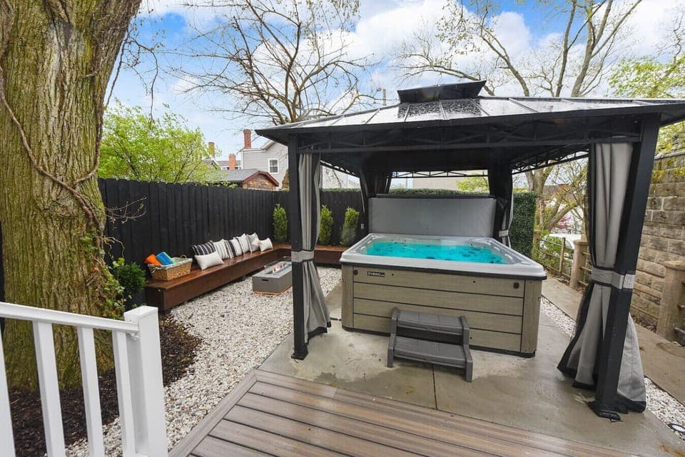 Relax in the outdoor hot tub with a beautiful garden view