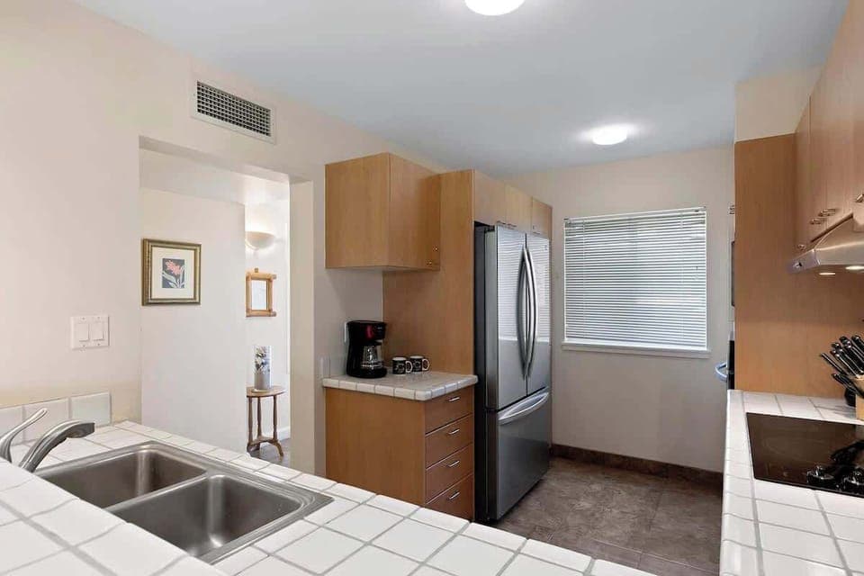 Create island feasts in this charming kitchen with stainless steel appliances and sunny vibes.