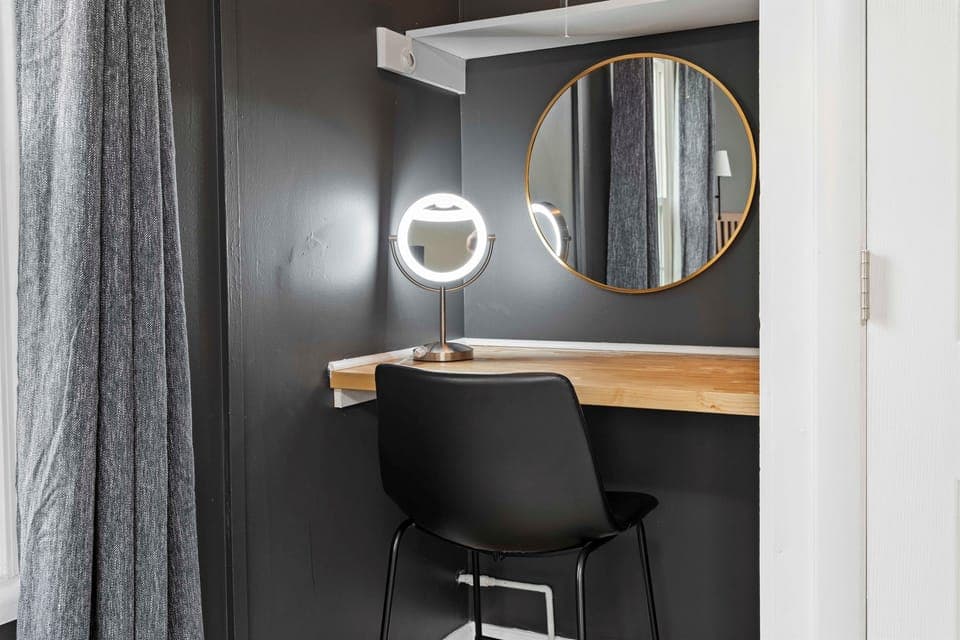 ✨ Your Personal Prep or Productivity Corner Whether you're glamming up for a night out or catching up on emails, this sleek nook with a lighted mirror and minimalist desk setup has you covered in style.