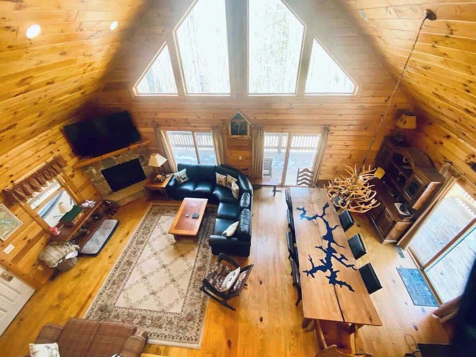 Living room from 3rd level.  New leather couch.  Warm easy on (switch) fireplace.  Locally sourced wood table with Deep Creek inlay just custom designed by a local craftsman.  