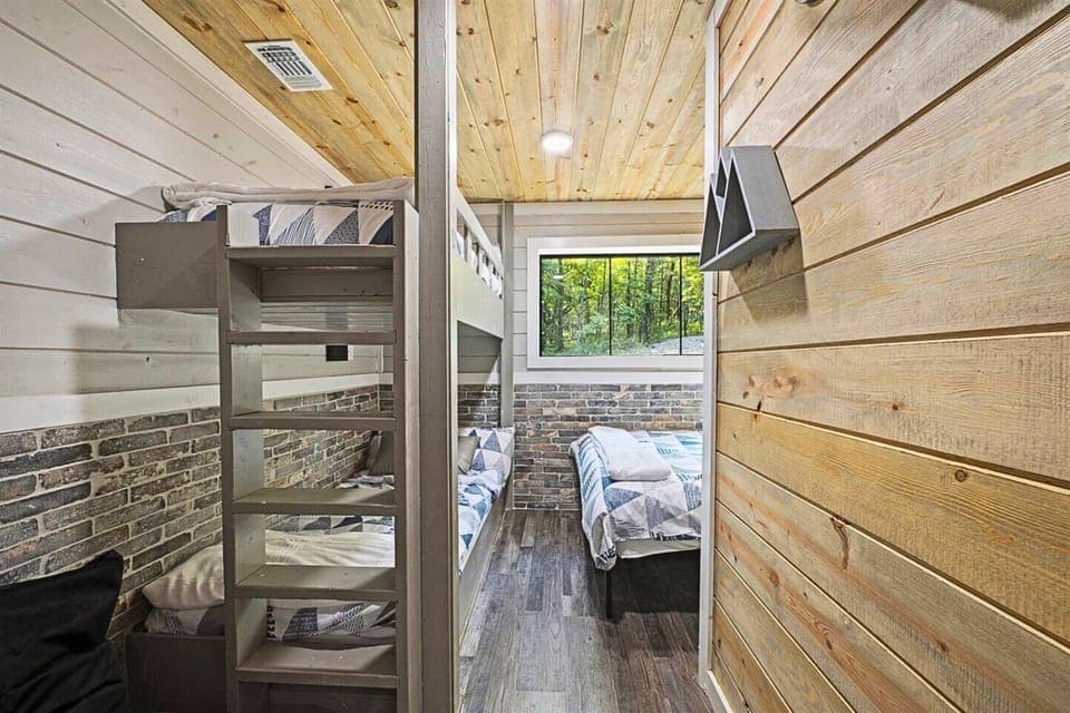 This spacious fifth bedroom is perfect for kids or groups, offering a mix of double and single beds to ensure everyone sleeps comfortably.