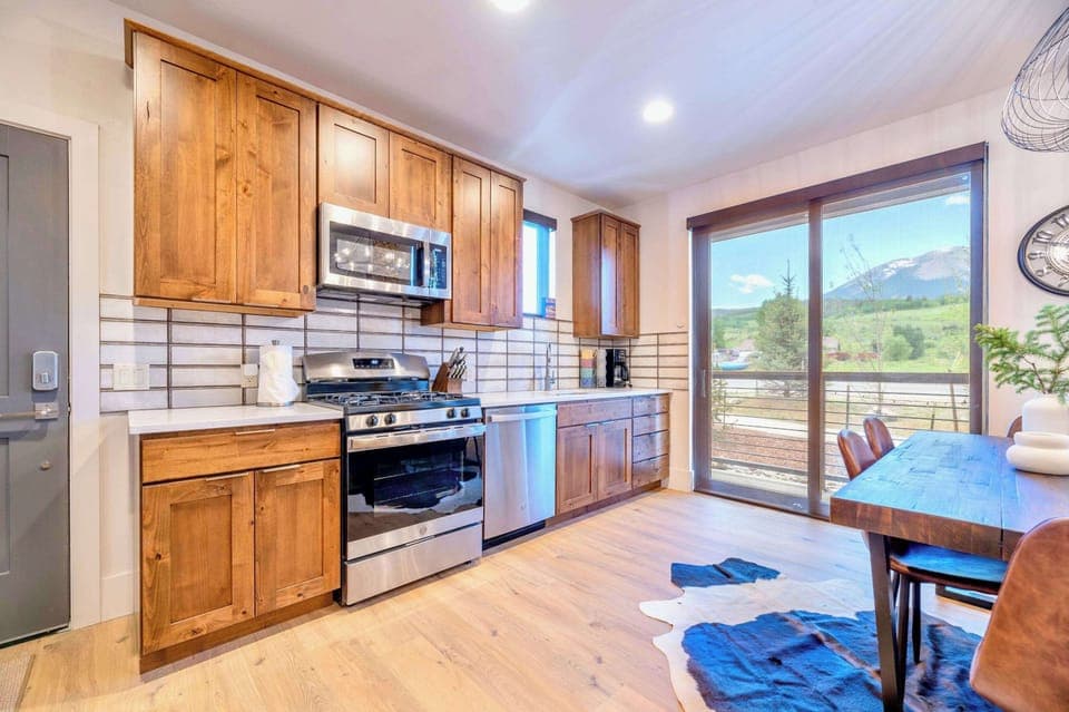 Fully Equipped Kitchen With Modern Appliances And Natural Wood Finishes