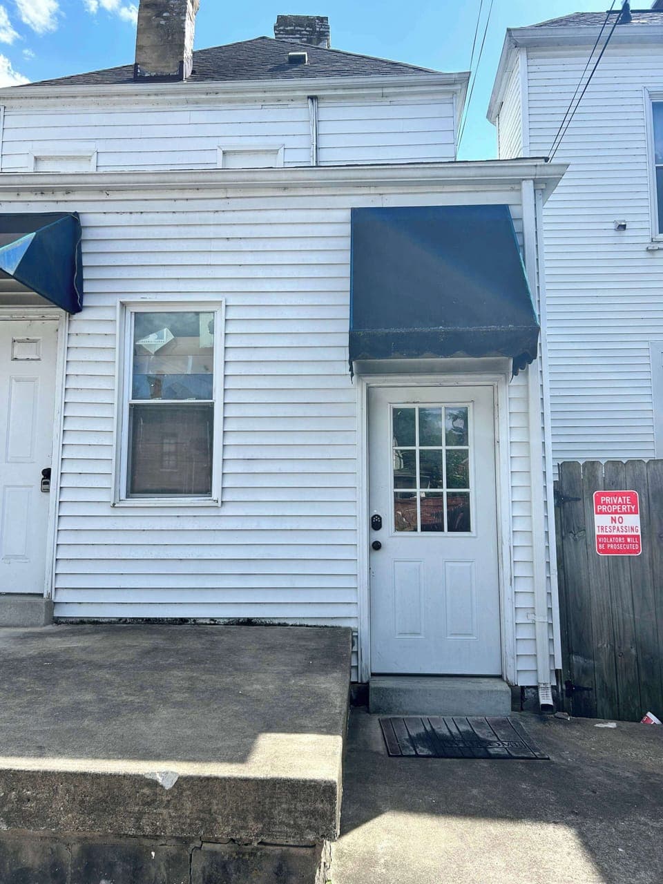 Entrance is the door on the Right 
From the rear of the building. 
You will enter from the rear of the building. Drive through the back alley and park in the back of the building. Parking is behind the building