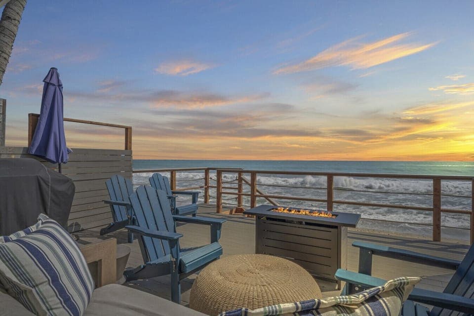 Breathtaking sunset views from the oceanfront deck with a cozy fire pit. 
