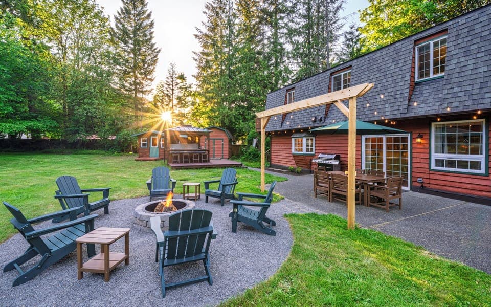 Spacious backyard with fire pit, BBQ grill, outdoor dining, and private hot tub
