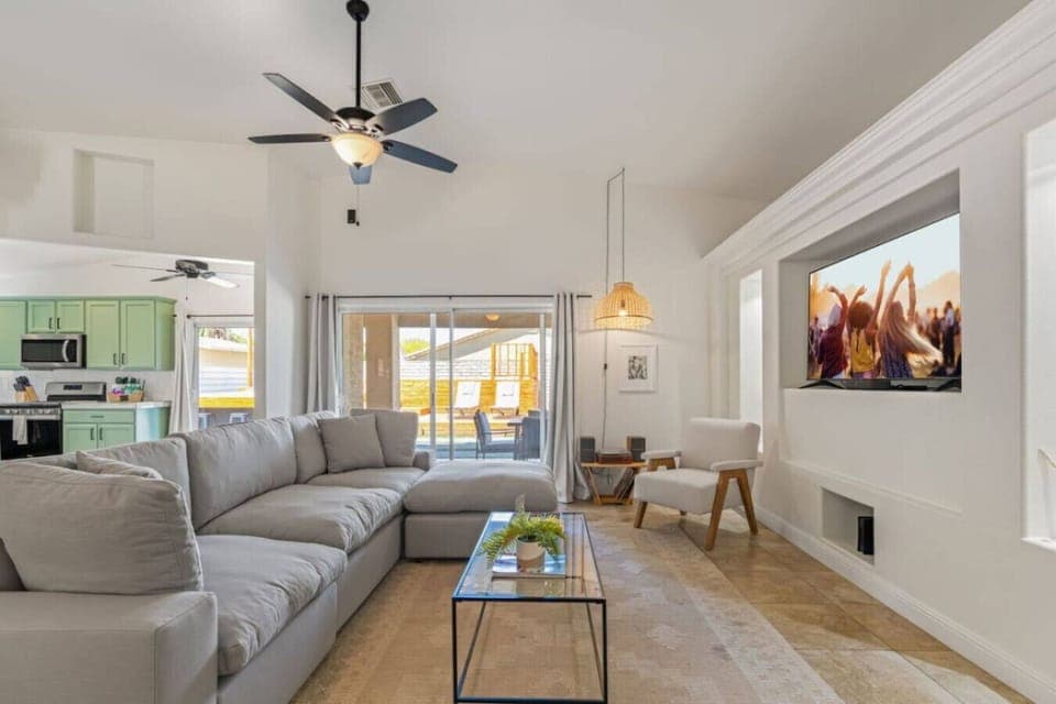 Bright living area w/ comfy seating & large sliders that open straight to the backyard pool space.