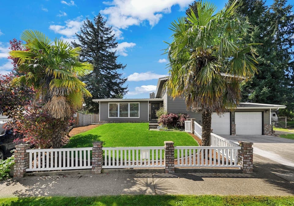 Green garden with palm trees provides a vacation feel to your stay.