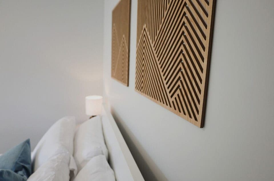 Thoughtfully styled with modern wood art and ambient lighting, this bedroom blends comfort with a touch of design flair.