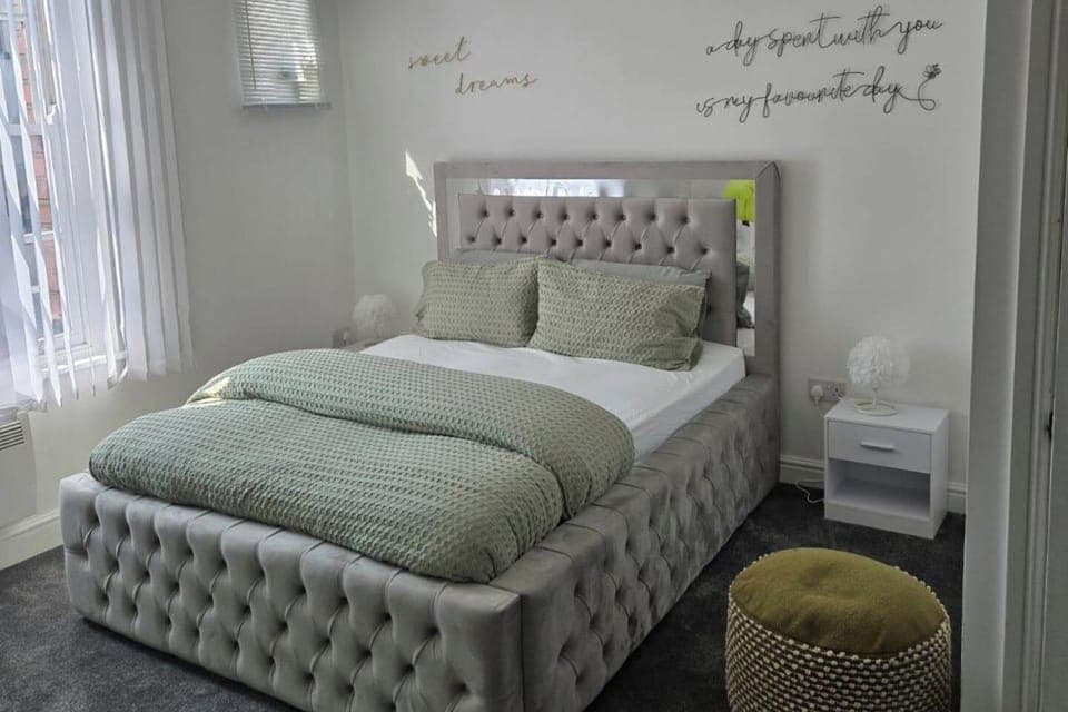 A warm cozy bed in a bedroom 