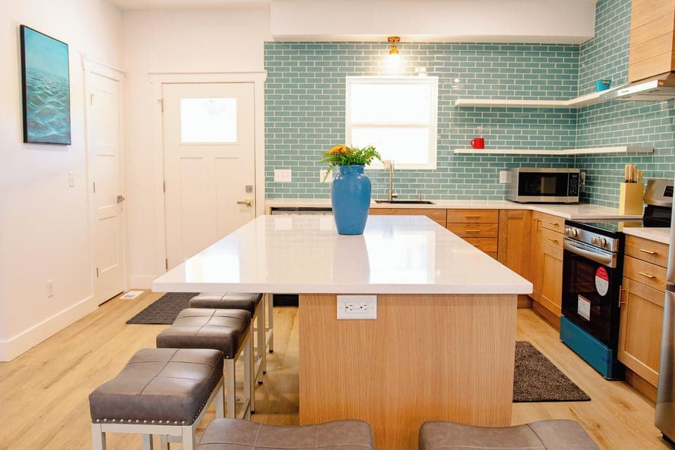 Large kitchen area with island and chairs