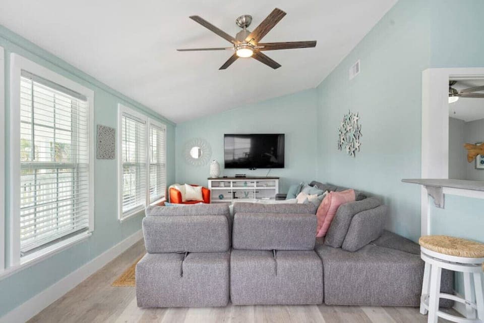 Living room right as you enter. Inviting ambiance enhanced by beautiful natural light