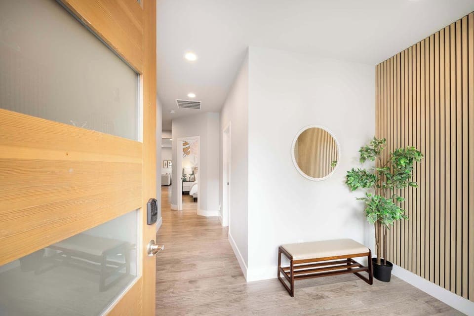 A convenient shoe bench and a full-length mirror offer both functionality and style for guests when entering home.