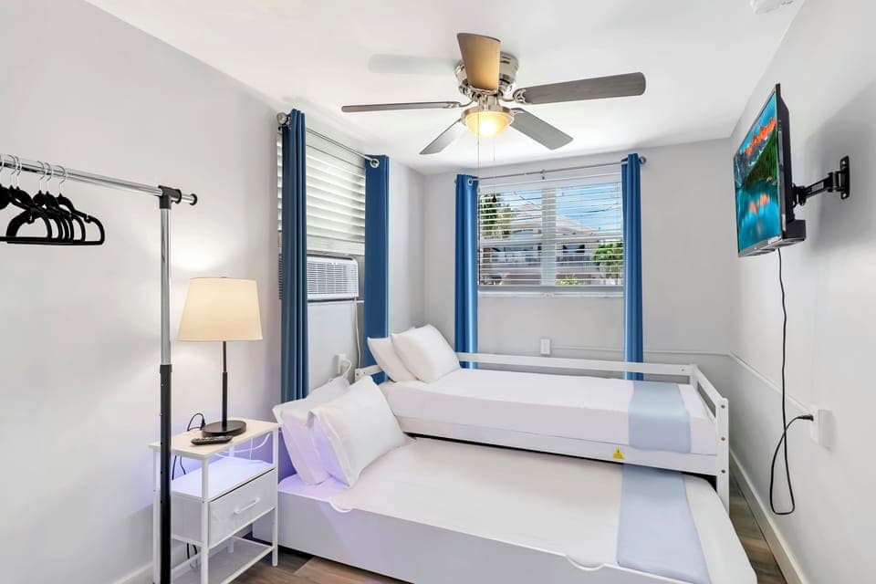 Bay Escape Home | Cozy bedroom with two twin trundle beds and a 32" smart TV.