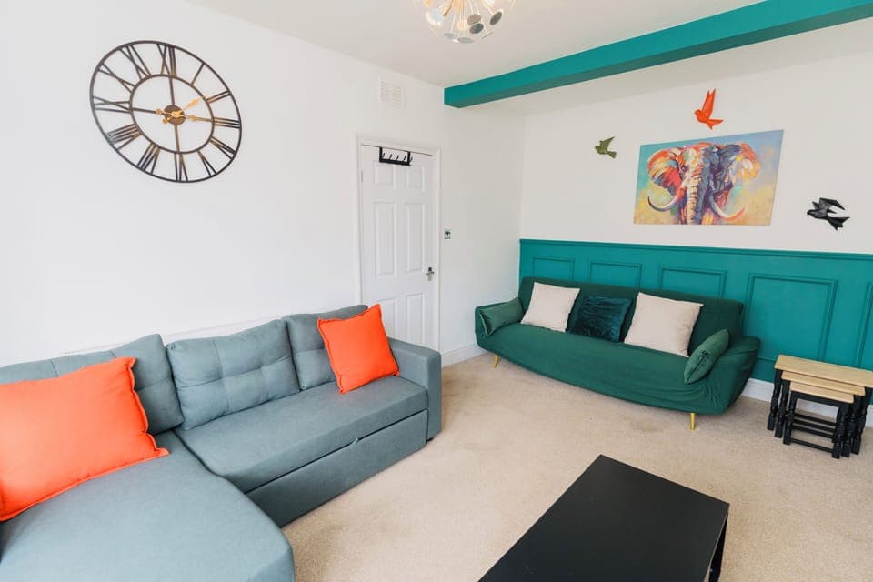 Green 3 seater click clack sofa & offers 45 degrees - great for movie night!