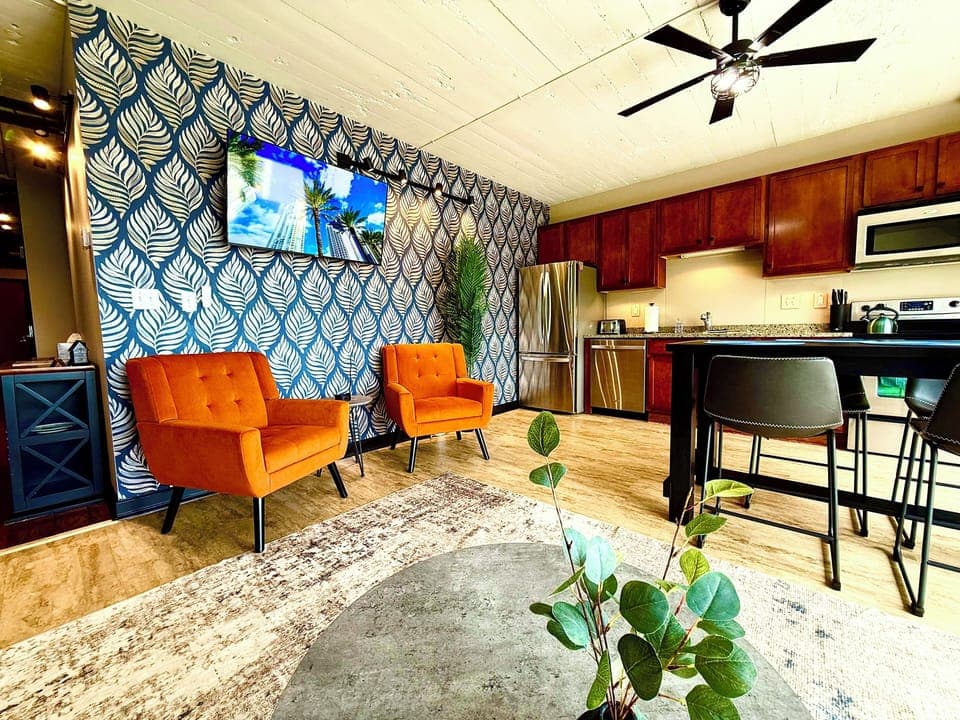 Vibrant Lounge Area
Bold wallpaper and modern art add flair to this inviting lounge with plush chairs and mounted TV—perfect for relaxing after a day by the lake.