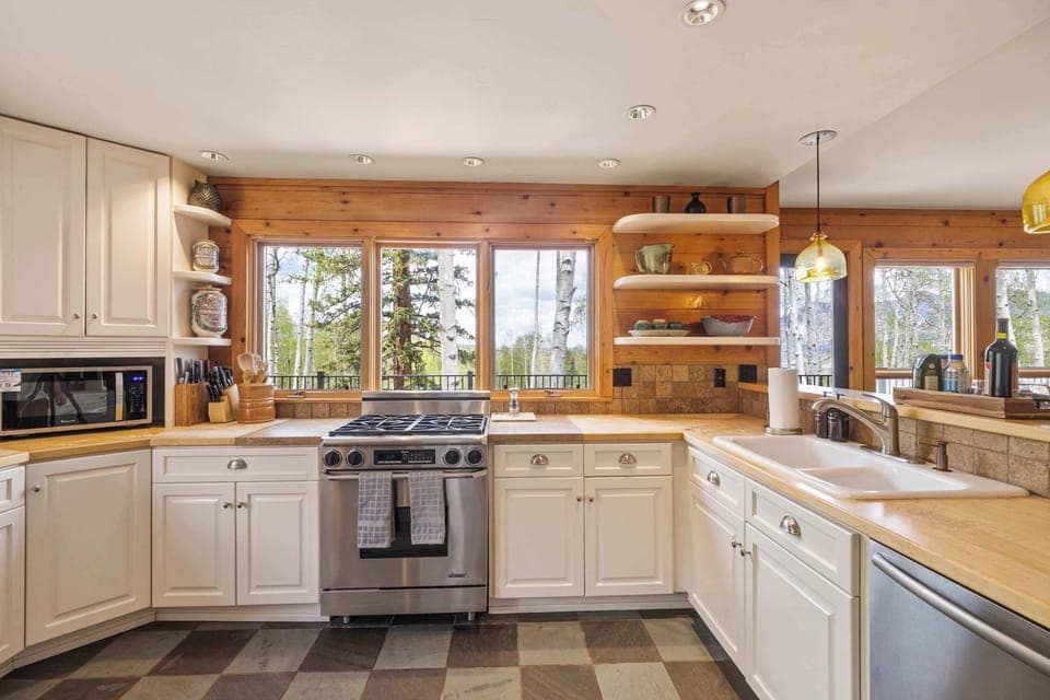 Kitchen: Main floor, Dacor oven, Jenn-Air fridge, drip coffee maker, French press, blender, toaster oven, food processor, cooking utensils, tableware