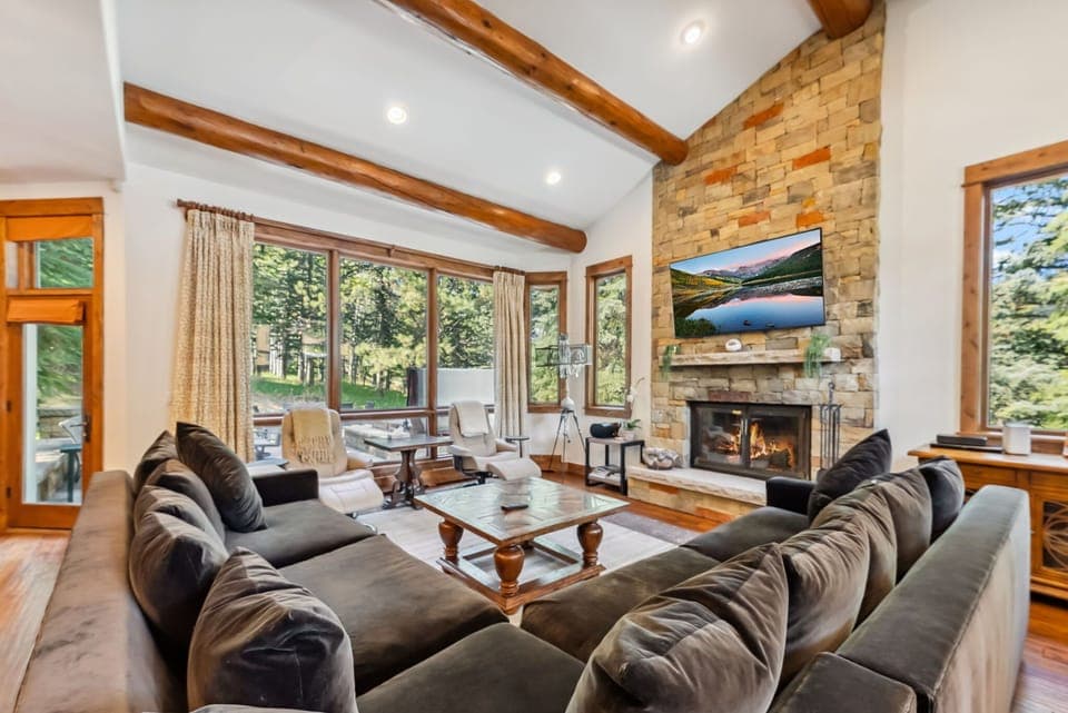 Living room: Main floor, wood-burning fireplace, Smart TV, Sonos speaker, deck access