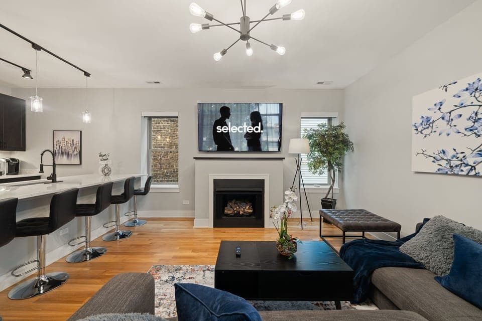 Open living area w/ comfy seating centered around a warm fireplace.
