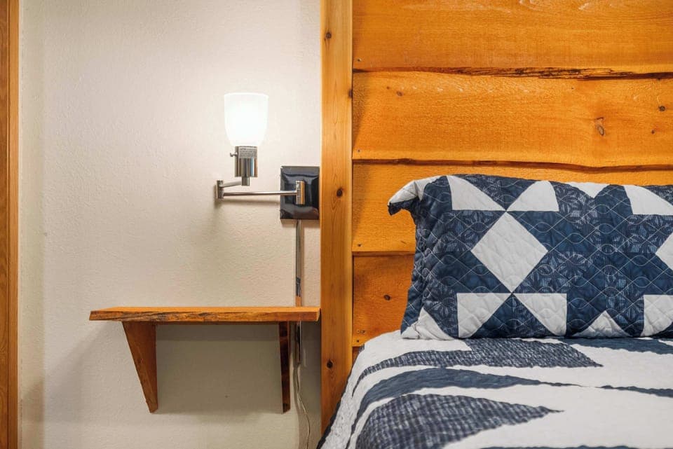 Bedroom 2 with king bed, deck access, TV, and ensuite