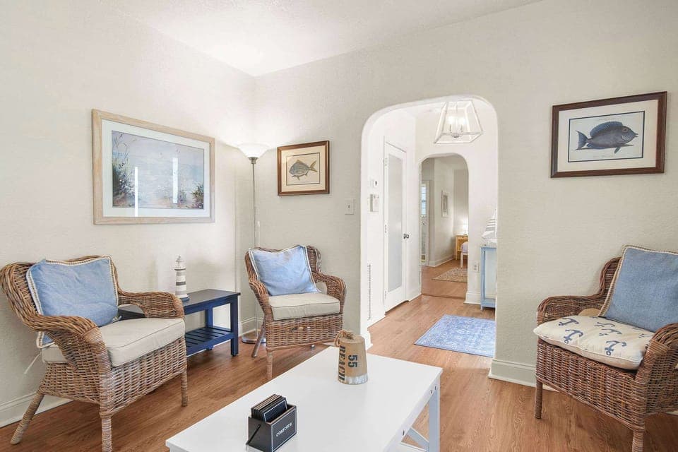 Relax in this charming living space with cozy wicker seating and nautical decor, perfect for unwinding after a day of exploring.