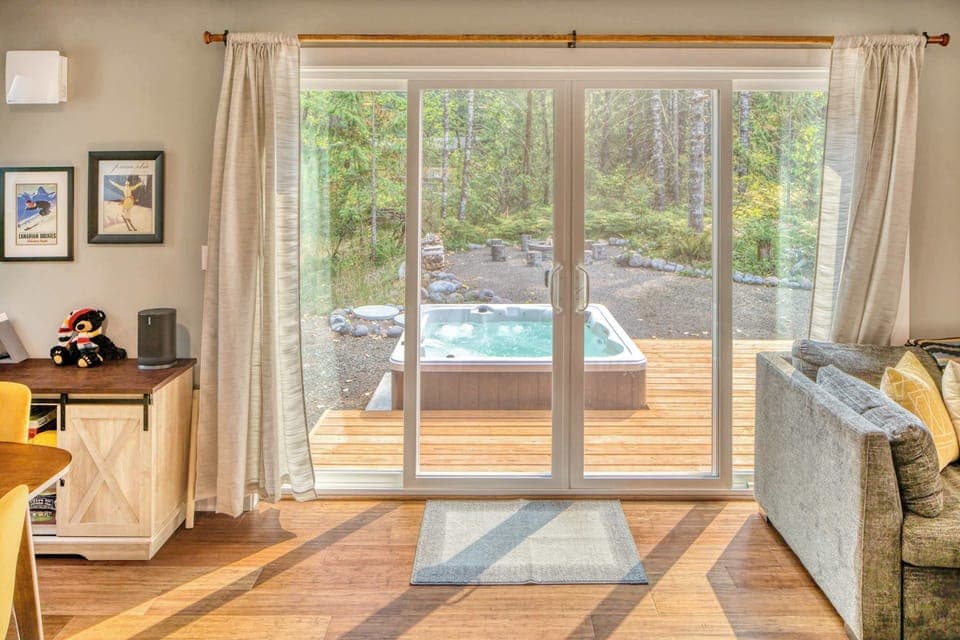 Step out and soak in your private hot tub! Forest views and relaxation await just beyond your door.