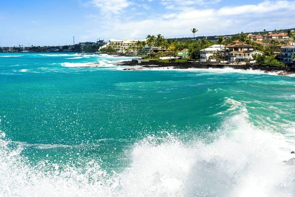 Crashing waves and stunning shoreline scenes capture the energy of Kona’s coast.