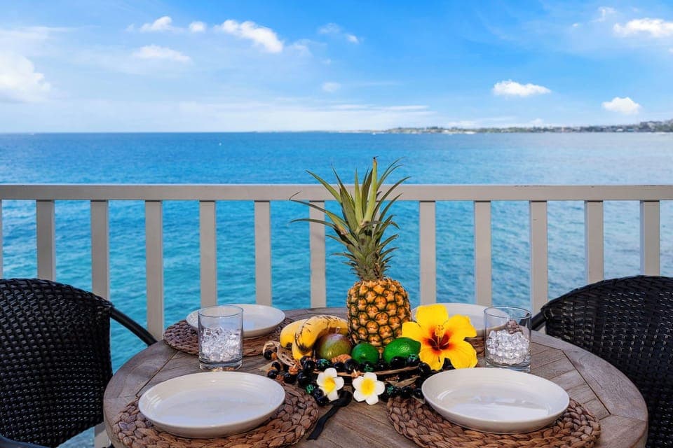 Start your mornings with Kona coffee and fresh fruit on your private oceanfront lanai—panoramic Kailua Bay views included.