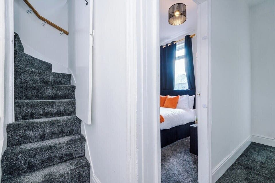 Aesthetic bedroom featuring warm orange and crisp white accents.