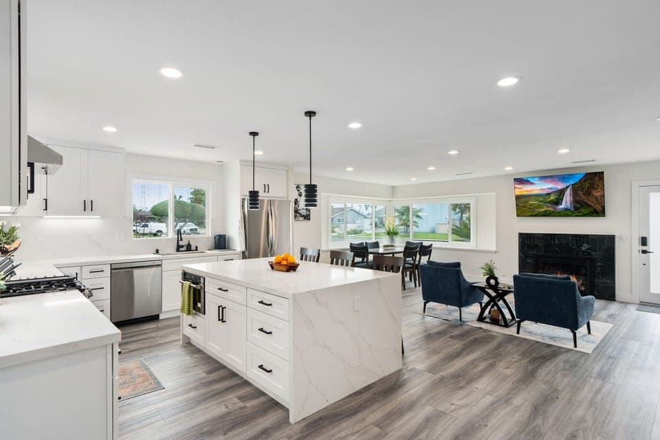 Sleek, open-concept living with a modern kitchen, lounge, and sunlit dining.