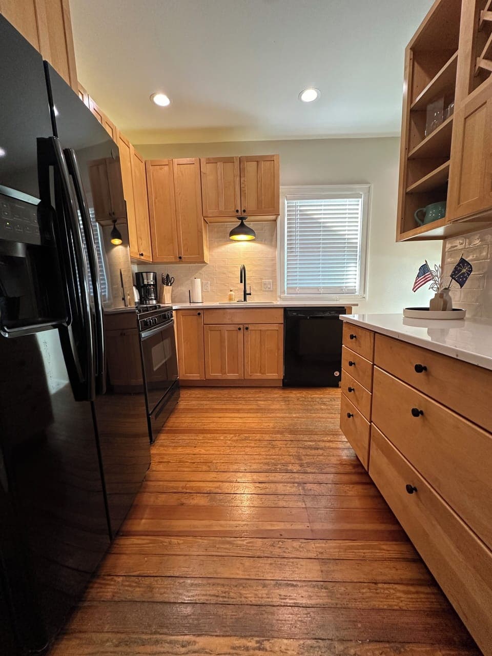 Fully stocked kitchen with coffee makers, cookware, and modern appliances.