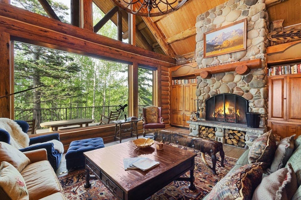 Beautiful Great room with high ceilings, wood burning fireplace and large flat screen TV for entertainment.