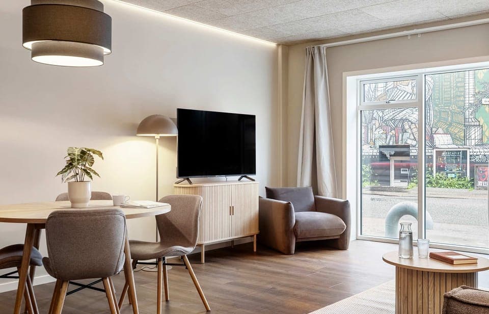 Room view with natural light and both blackout curtains and a thin layer of curtains, to ensure your privacy