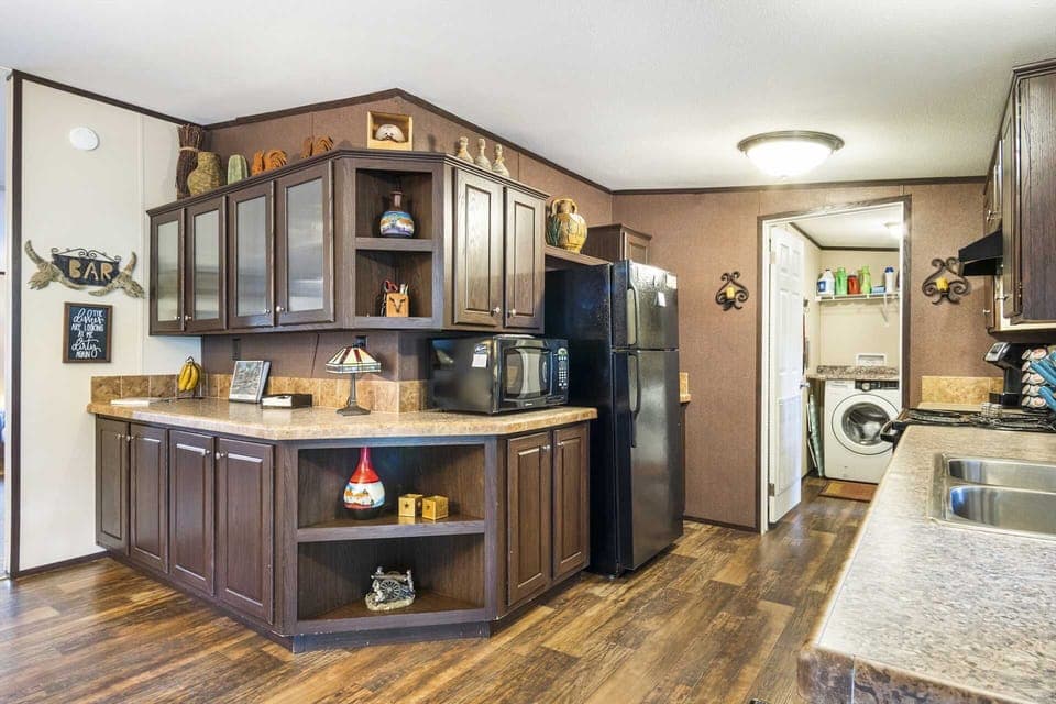 Charming kitchen with full appliances, rustic decor, and convenient access to the laundry room for a hassle-free stay.