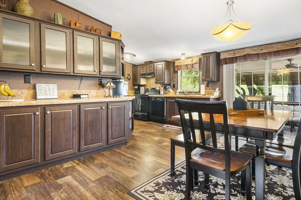Cozy kitchen and dining area with warm wood finishes and views of the peaceful outdoors-perfect for family meals and gatherings.