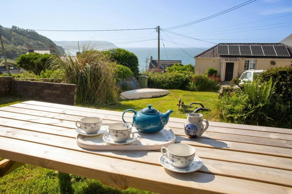 Rear garden with picnic table and sea views