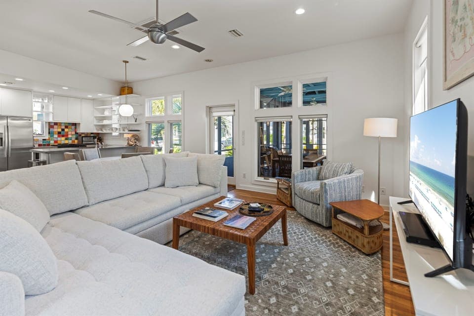 Sink into plush seating while enjoying your favorite shows on the large TV in this bright, airy living space.