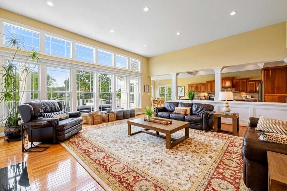Great Room - Leather sofas, a large area rug, and an open layout flowing into the kitchen create a comfortable gathering space.