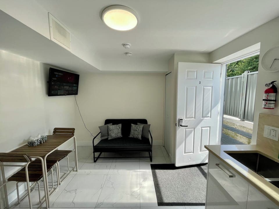 Living Room with Sofa-bed, dining table, with 2 chairs and 2 stools.