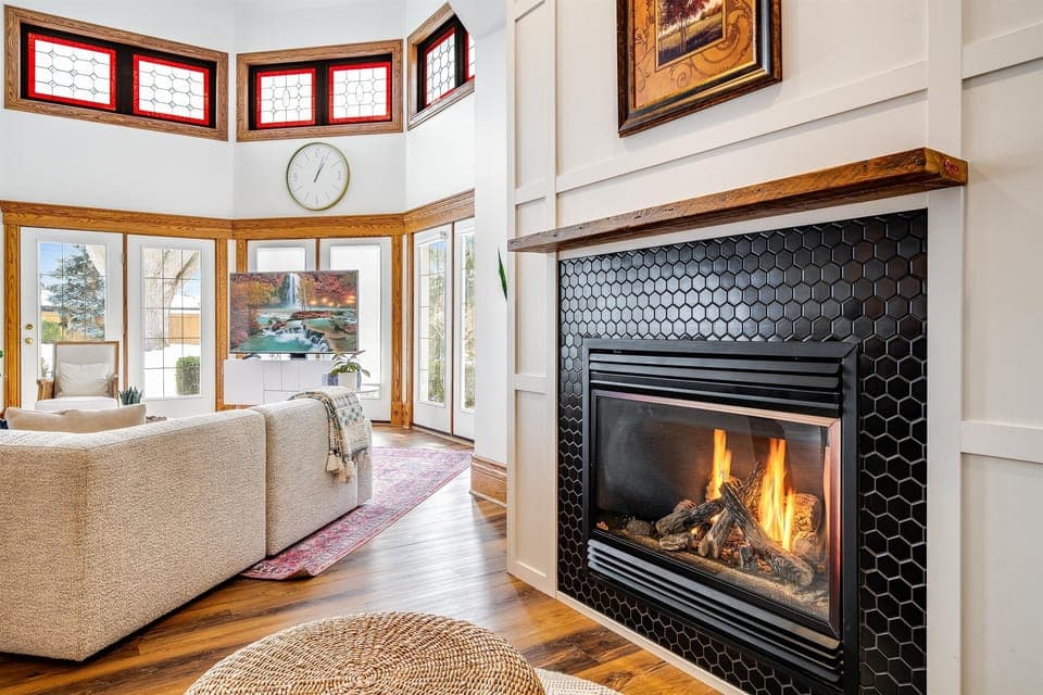 An open heart of the home, where chestnut warmth meets ivory walls and ruby-tinted sunlight flickers like firelight