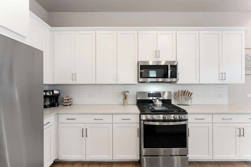 Modern, bright kitchen with stainless steel appliances, spacious countertops, and ample storage. Ideal for cooking during long stays. Your home away from home!
