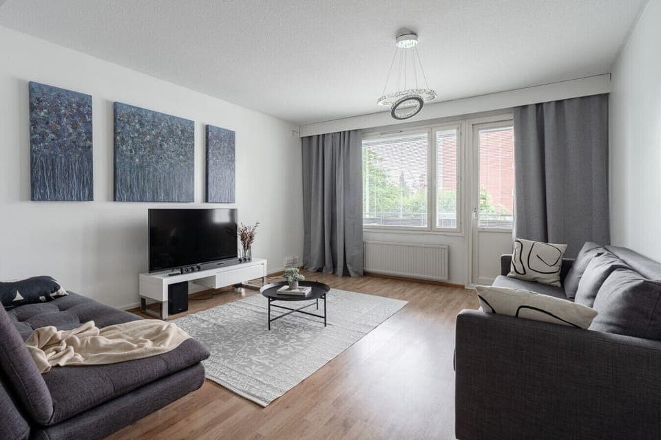 Bright, stylish living room with cozy seating, perfect for relaxing after exploring Jyväskylä.