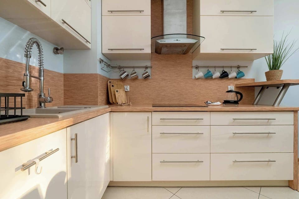 A modern kitchen with a spacious countertop and full equipment inspires you to cook your favorite meals.