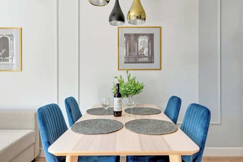 A bright room with large windows, soft lighting, and minimalist decor.