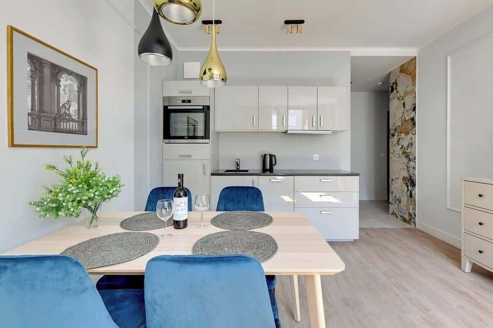 A sleek kitchen with modern appliances, a clean design, and a cozy dining area.