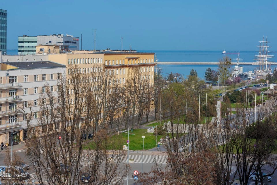 The apartment’s location offers a view of the sea and nearby port, adding a unique atmosphere.