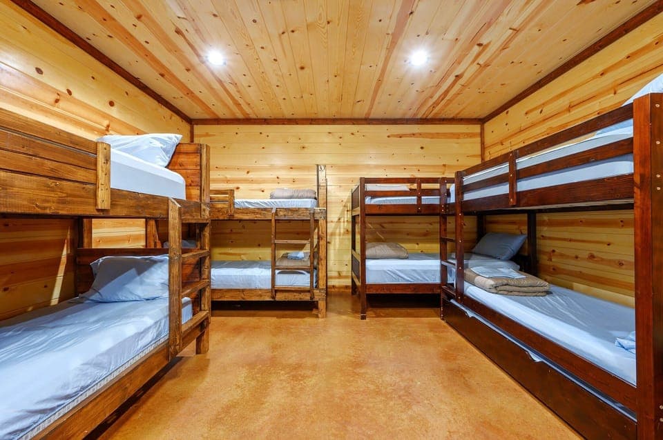 The 2nd bedroom offers a queen bed, 4 twin-over-twin bunkbeds, a twin trundle, & smart TV​