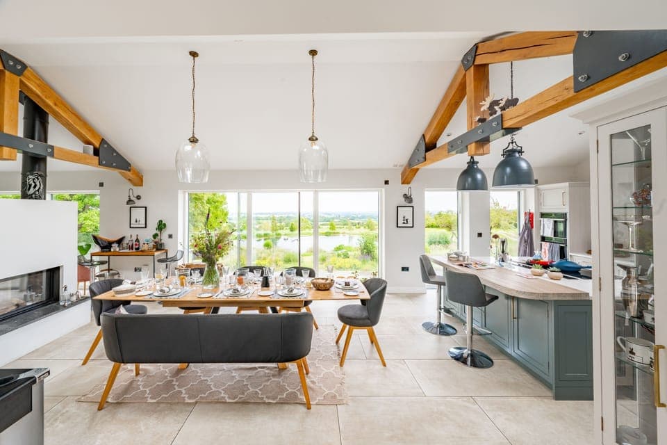 The open-plan living space boasts exposed beams