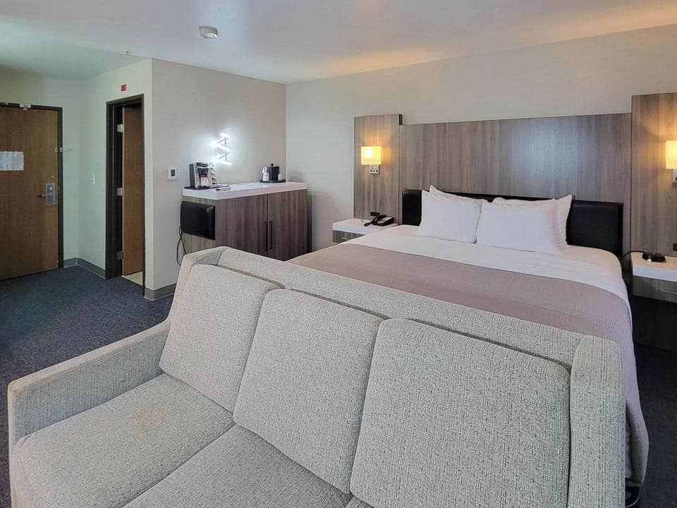 Premium bedding, desk, laptop workspace, blackout drapes