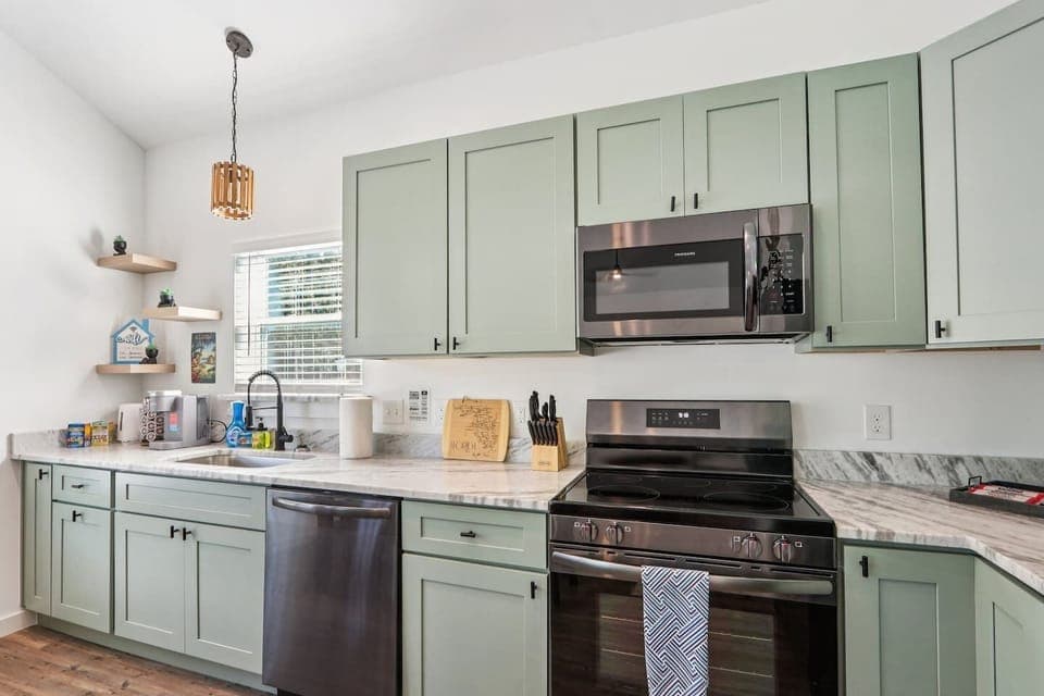Full kitchen with refrigerator with water and ice dispenser, stove, oven, keurig with pods, hot water heater, toaster, pots/pans, baking sheets, cooking utensils, mixing bowls, plateware for 12, kids plateware, cups, wine glasses, coffee mugs, + more